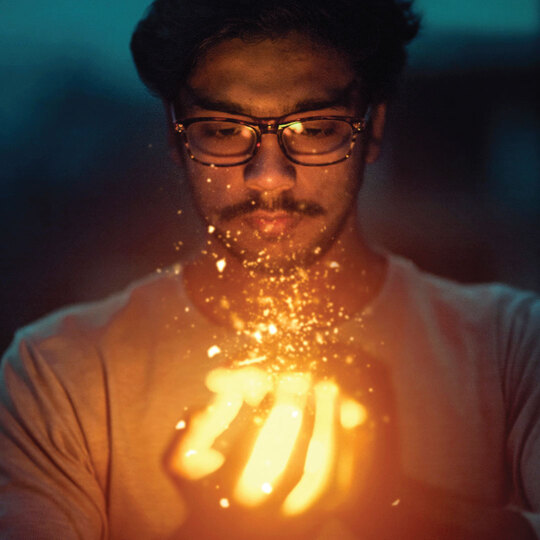 man holding the flaming power of knowledge he got from tutorials